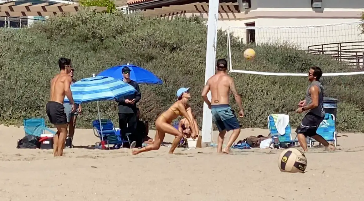 My ball! Alessandra Ambrosio dives for the ball as she hit the sand in a gold nude bikini © The MEGA Agency