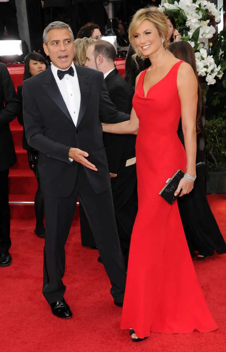 George Clooney is the perfect gentleman at the Golden Globes helping girlfriend Stacy Keibler down some stairs, LA