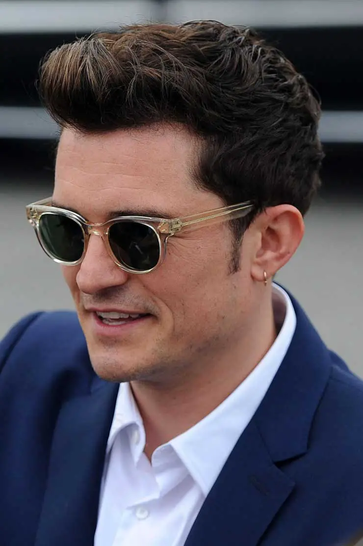 Orlando Bloom shows off his earring in stylish Oliver Peoples sunglasses, LA