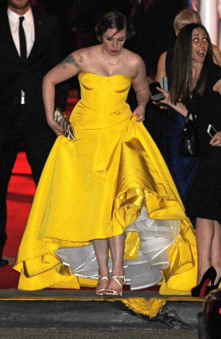 Lena Dunham hiked up her bright Zac Posen dress and showed off her Jimmy Choo Shoes © Atlantic Images