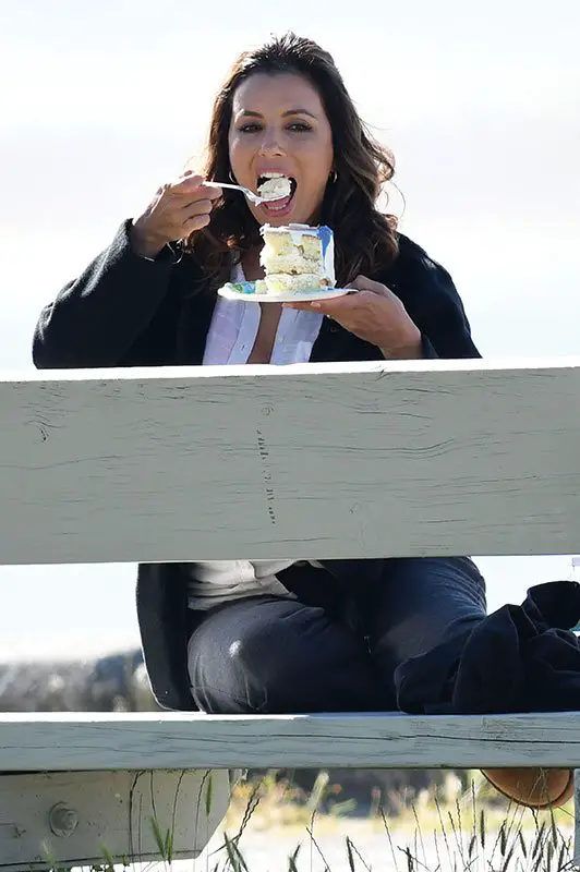 Eva Longoria enjoys a break from filming as she tucks into a huge cake in Canada! © Atlantic Images