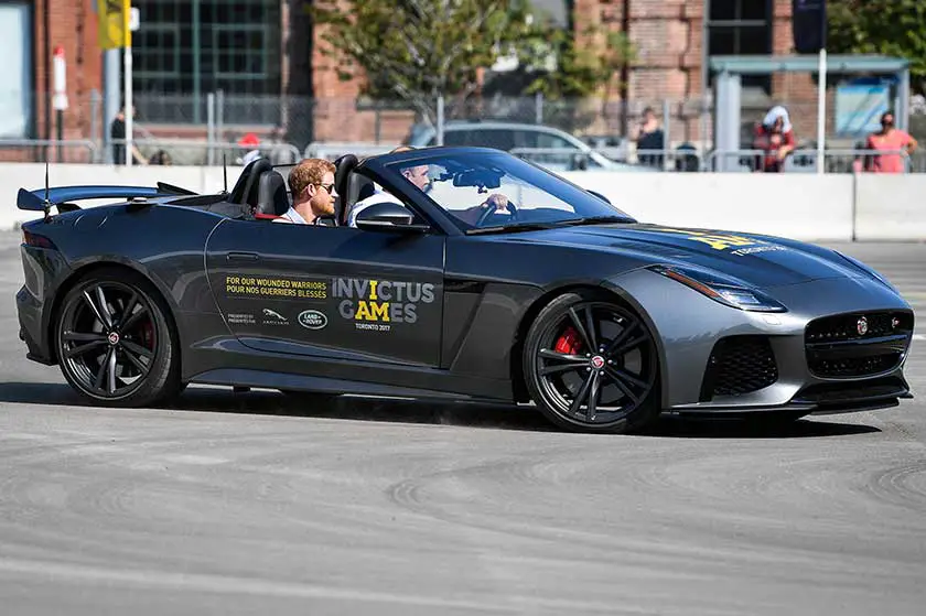 Prince Harry sat in the passenger seat as he was given a ride in the convertible Jaguar F-Type