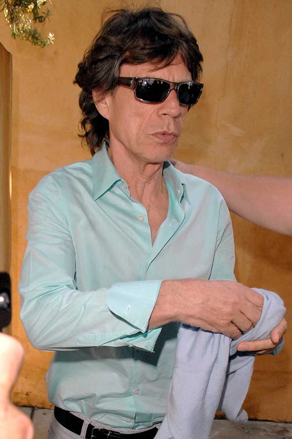 Mick Jagger was spotted being sneaked out of a restaurant in Beverly Hills, Los Angeles with a bodyguard leading the way and a bunch of photographers waiting to get a snap of the iconic and legendary Rolling Stones singer
