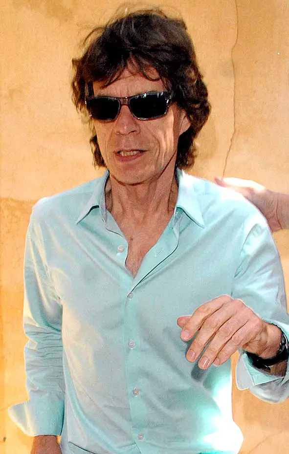 Mick Jagger was spotted being sneaked out of a restaurant in Beverly Hills, Los Angeles with a bodyguard leading the way and a bunch of photographers waiting to get a snap of the iconic and legendary Rolling Stones singer