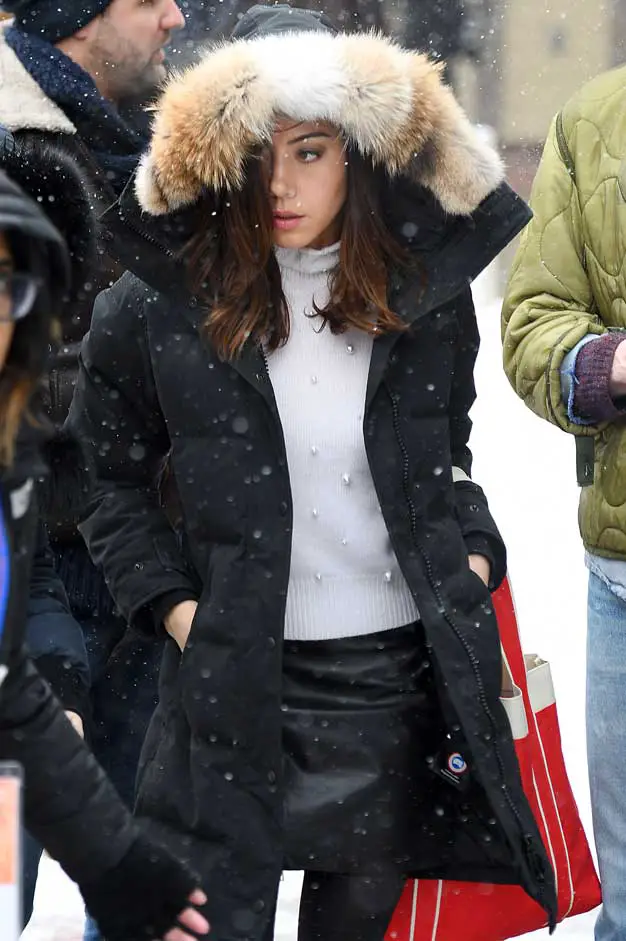 Aubrey wrapped up warm in her Canada Goose parka and matched it with a white roll neck sweater