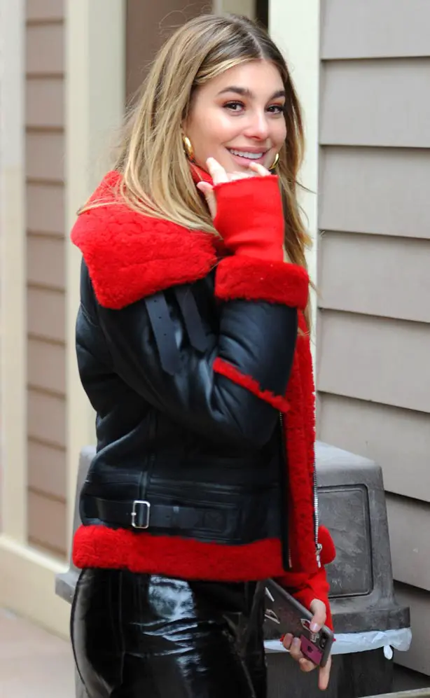 Camila Morrone showed off her winter style in a Sandro Paris Officiel black and red mens jacket and gold Jennifer Fisher earrings