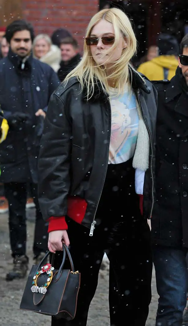 Elle matched her outfit with a small leather handbag with jewels attached
