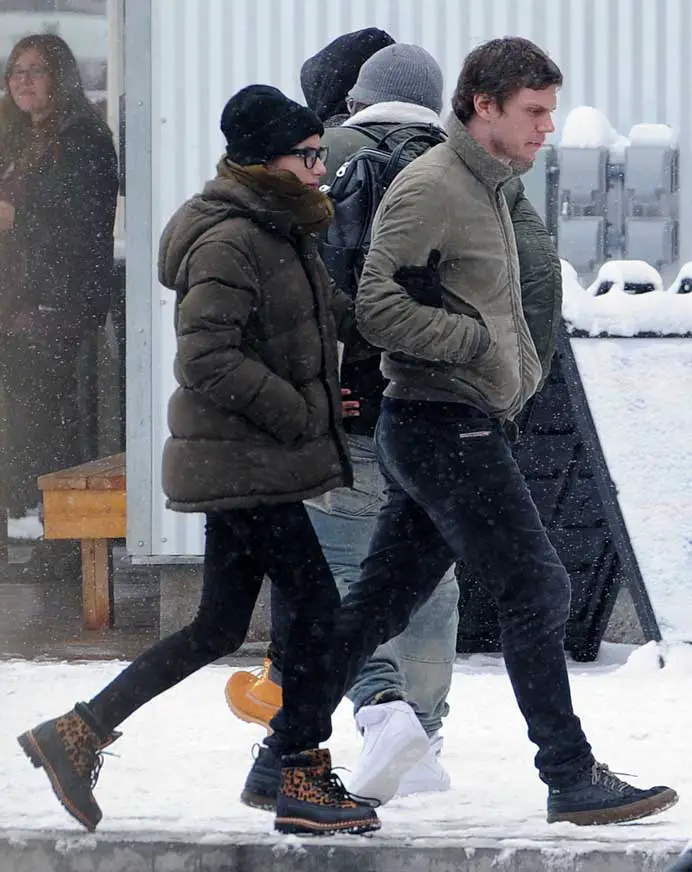 Let's go! Evan Peters led the wa with Emma Roberts grabbing on to his arm in the wintery conditions