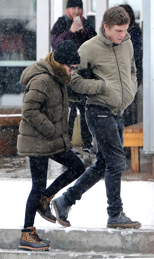 Wearing leopard patterned winter boots, Emma held on to Evan’s arm as they walked down some icy steps