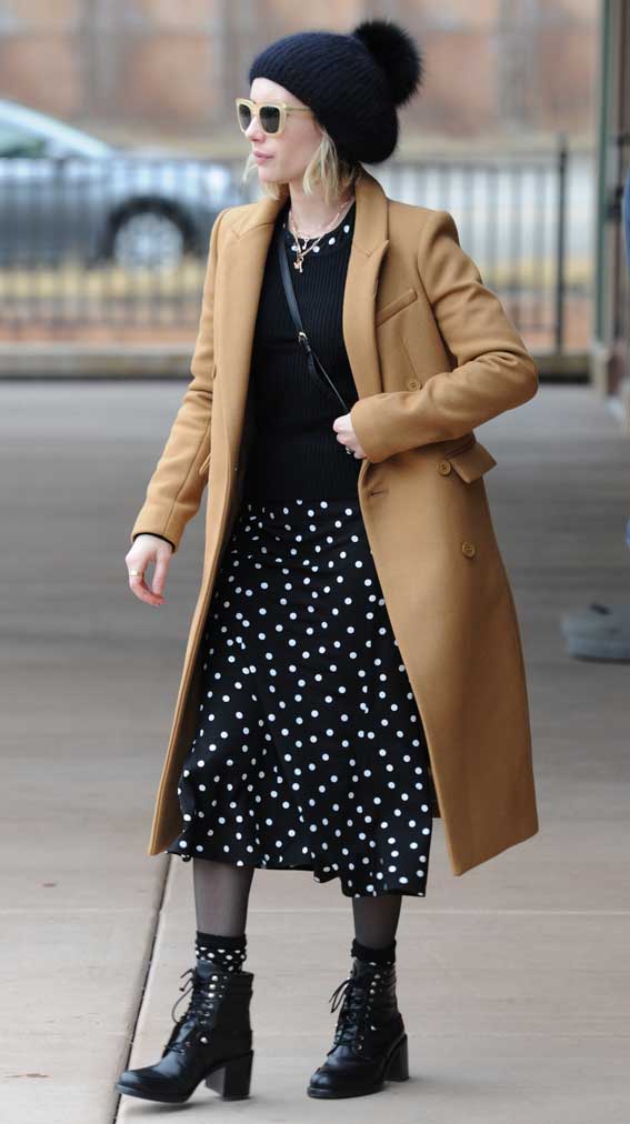 Emma Roberts at 2018 Sundance Film Festival wearing a Polka Dot dress, a beige winter floor-length coat and killer leather boots