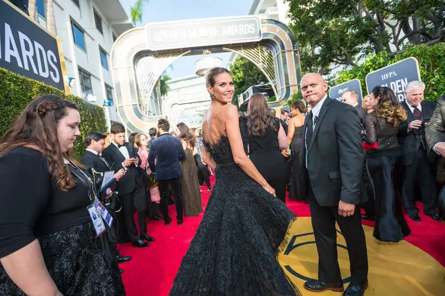 Heidi Klum posed over the shoulder in an Ashi Studio black dress at this years Golden Globes © HFPA