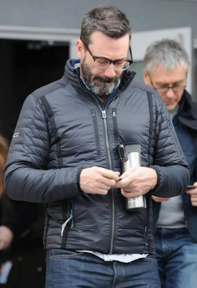 Who called? Jon Hamm checks his messages after being interviewed for his new movie 'Beruit'