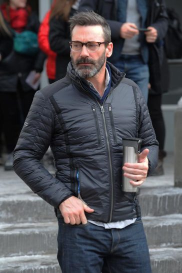 Jon Hamm carried a flask with him wrapped up warm in a winter jacket