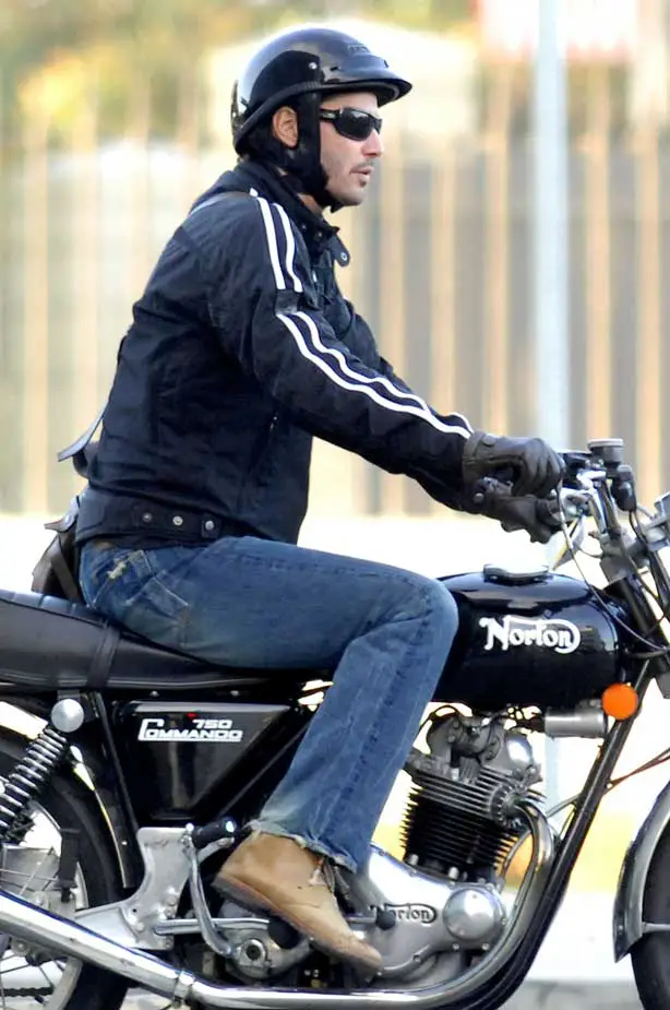 Keanu Reeves took his Norton 750 Commando for a spin around Los Angeles wearing a black helmet, matching black sunglasses, a striped jacket, jeans and boots © Atlantic Images