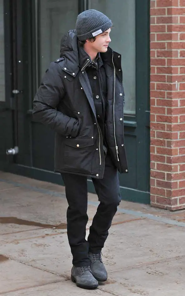 Logan, who is well known for playing Percy Jackson in the same named films, matched his look with a long buttoned jacket and grey boots © Atlantic Images