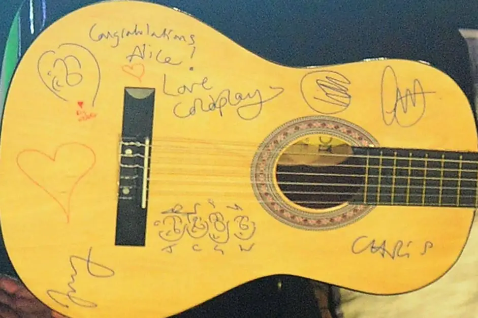 Chris Martin signed Coldplay guitar with cartoon caricatures drawn on at the BBC Radio 1 Teen Awards