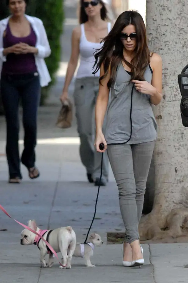 Kate Beckinsale walking Puppy dog Ingrid Wearing Heels skinny jeans and a vest showing off her fashion in Sunglasses