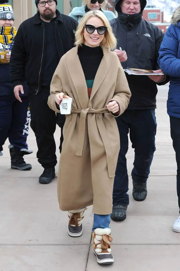 Naomi Watts stepped out in an unusual outfit but also promoted a positive message with her coffee cup reading “Good Vibes Only” Sorel Boot Trenchcoat 2018 sundance Film Festival promoting Ophelia Film