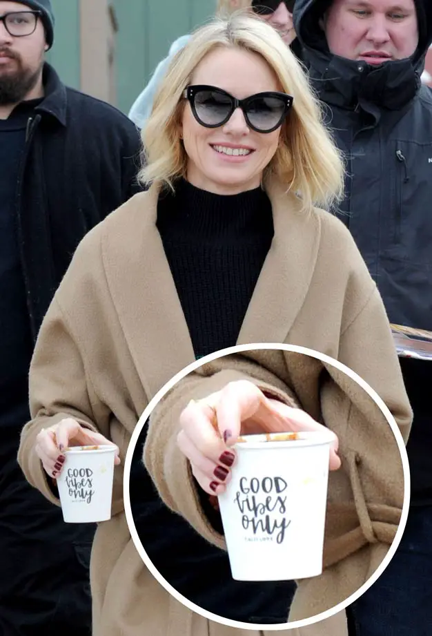 Naomi Watts stepped out in an unusual outfit but also promoted a positive message with her coffee cup reading “Good Vibes Only” Sorel Boot Trenchcoat 2018 sundance Film Festival promoting Ophelia Film
