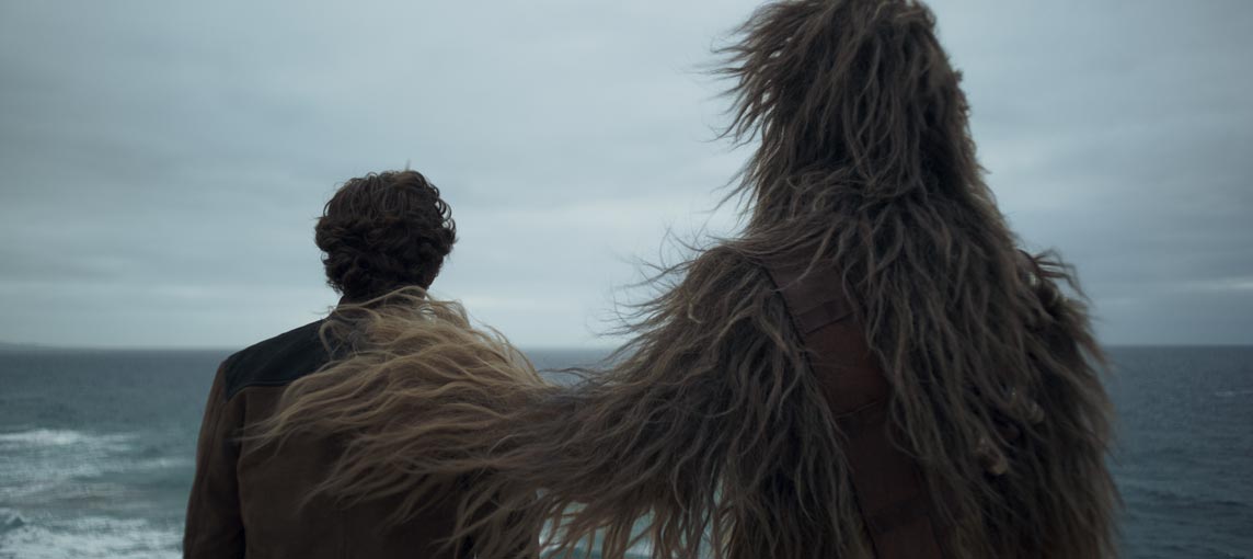 Solo: A Star Wars Story Stills In this touching image Chewbacca has his hand on Han's shoulder. In the backstory Chewbacca raised Han as an orphan