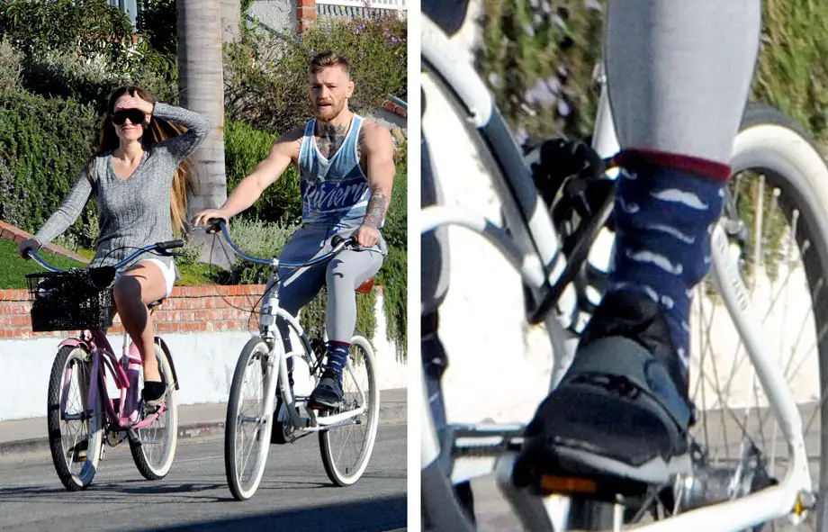Nice Mustaches! Conor McGregor had his sweatpants tucked into his mustache socks cycling with Dee Devlin! © Atlantic Images