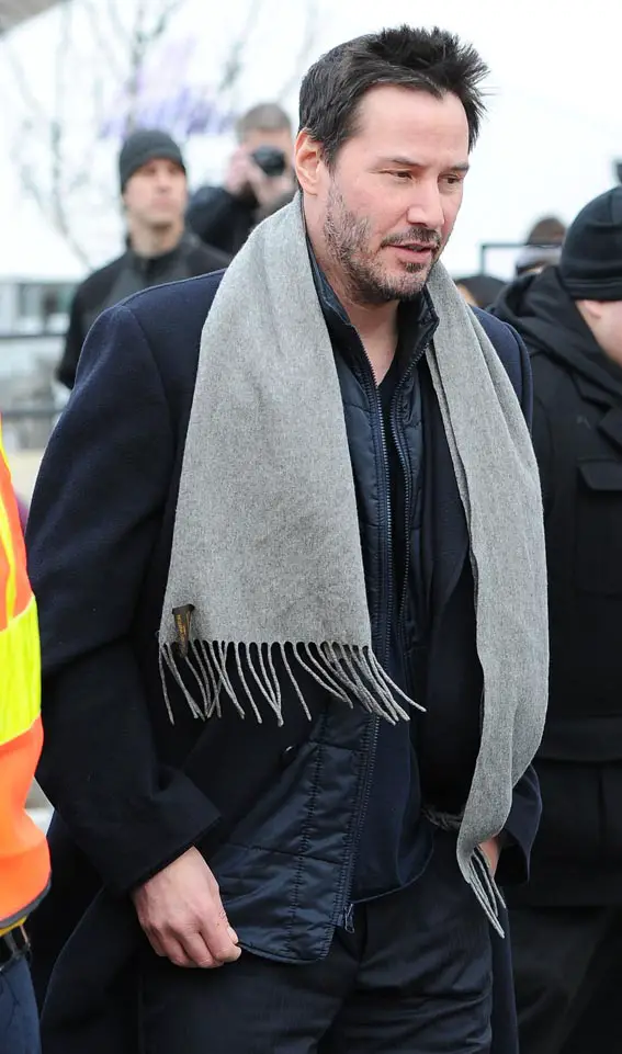 Keanu Reeves looked dapper in a smart winter jacket and grey scarf showing off a bit of grey in his beard