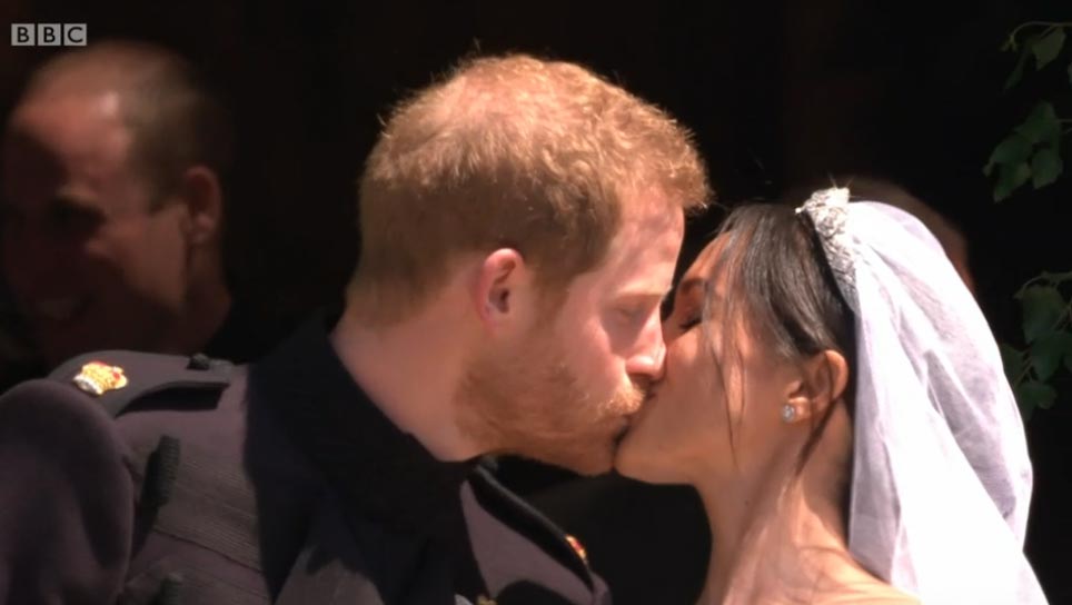 The Kiss! Meghan asked if they should kiss as they left the chapel and Harry obliged with a smacker! Images courtesy of © BBC