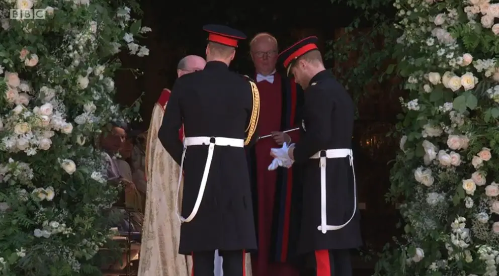 Prince Harry took off his white gloves to shake hands with the clergymen at St George's Chapel - Images courtesy of © BBC