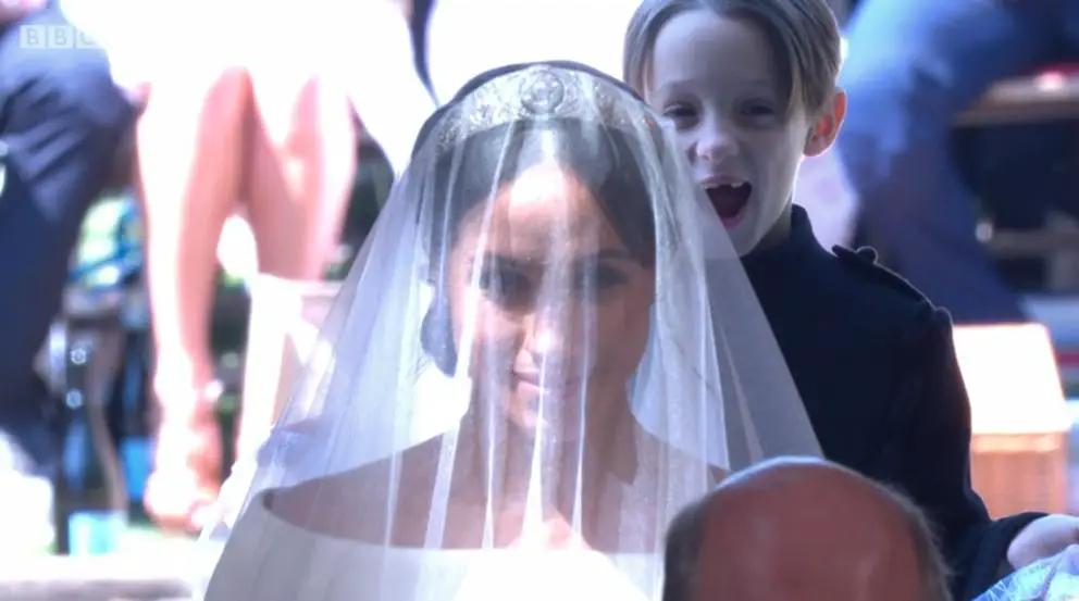 Meghan's pageboy couldn't help but yawn as her held on to her train in this light-hearted moment at the royal wedding - Images courtesy of © BBC