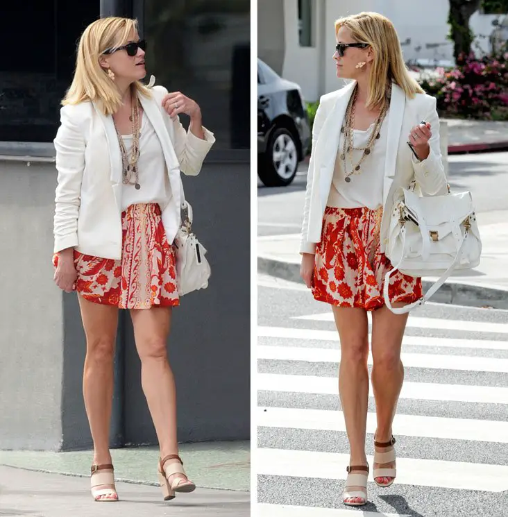 Reese Witherspoon showed off her summer style with a white blazer and red and orange patterned short skirt