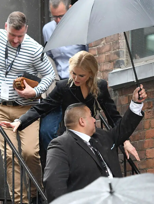 Nicole Kidman had her own umbrella holder as she carefully made her way down the wet steps at TIFF 2018