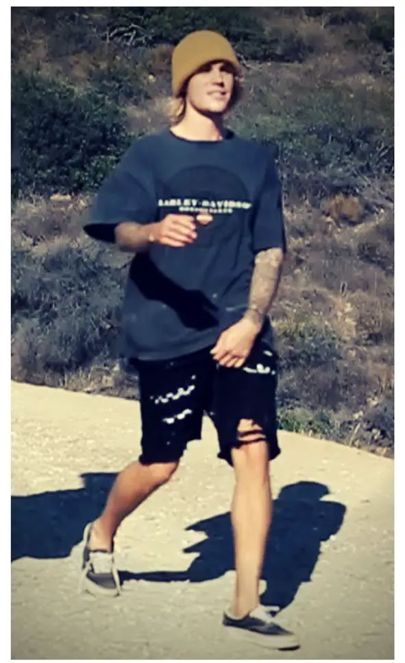 Justin Bieber wore a Harley Davidson tee with ripped shorts and a beanie despite the hot weather © The Mega Agency