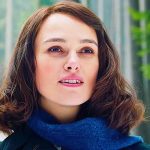 Keira Knightley with short hair and blue scarf looks lovingly off camera