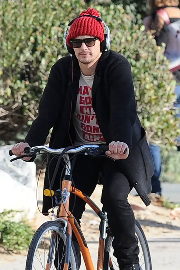 James Franco took a break on his bike wearing a red bobble hat and Beats Headphones © Atlantic Images