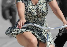 Kelly Brook in an extremely short skirt cycling on the beach © Atlantic Images