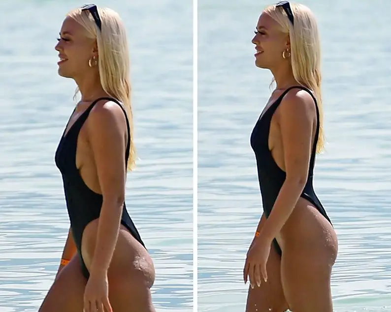 Lottie Tomlinson showed off her trim figure in a revealing black swimsuit © The MEGA Agency