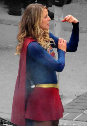 Melissa Benoist flexes her muscles as she grabbed on to her bicep filming the CW Supergirl show in Vancouver