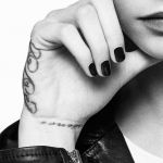 Cara Delevingne showed off two tattoos on her right hand - one with her initials CJD and the other that read 'Whisper'. Cara Delevingne showed off two tattoos on her right hand - one with her initials CJD and the other that read 'Whisper'.